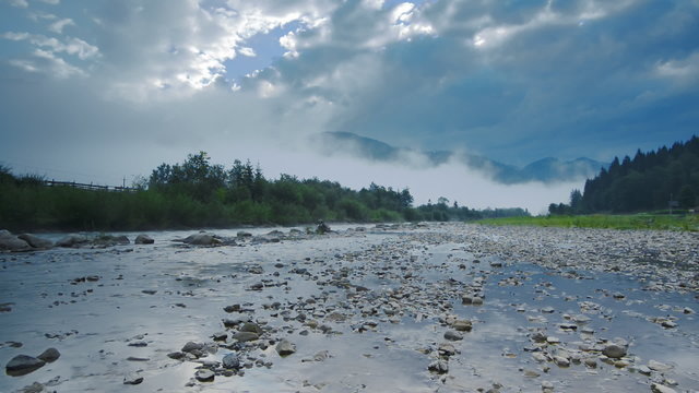 Morning fog in the mountains and the bridge over the rive