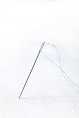 needle with the blue thread