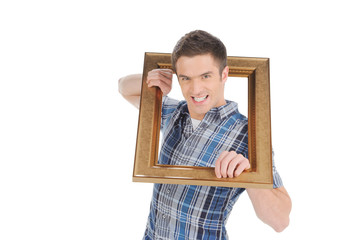 Man with picture frame. Handsome young man getting out of the pi