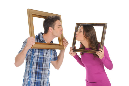 Couple with picture frames. Beautiful young couple holding a pic