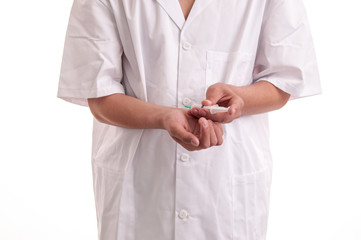 Closeup of young doctor injecting medicine in his hand