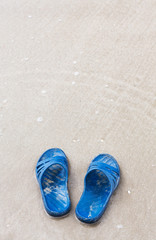 Fototapeta na wymiar Slippers on the beach