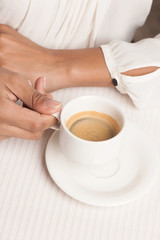 Woman with cup of coffee. Top view of woman holding a cup of cof