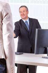 Businessman and Businesswoman in office
