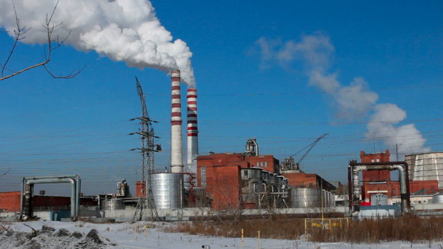 Pipes with  smoke against the blue sky in the summer