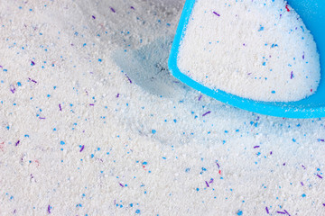 Washing powder in blue container closeup