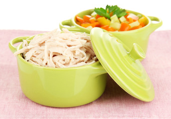 Shredded boiled chicken in green pan close up
