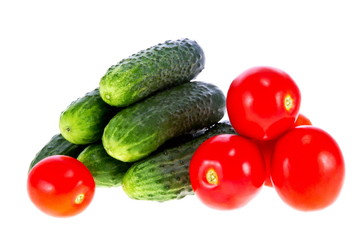 ripe tomatoes and cucumbers on a white background