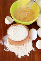 Ingredients for dough on wooden table close-up