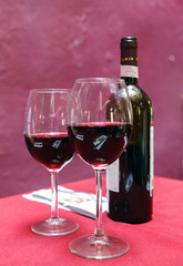 Wine glass and Bottle on a red background