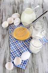 Ingredients for dough on wooden table close-up