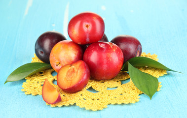 Ripe plums on wooden table close-up