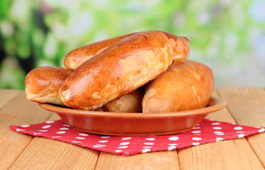 Fresh baked pasties, on wooden table, on bright background