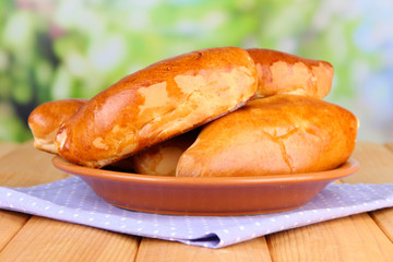 Fresh baked pasties, on wooden table, on bright background