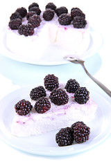 Cheesecake with fresh berries on white plate closeup