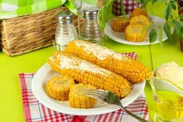 Flavored boiled corn on  plate on wooden table close-up