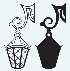 Silhouette lamp of wrought metal isolated on blue background