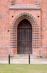 Wooden door to the Gothic church in Poznan