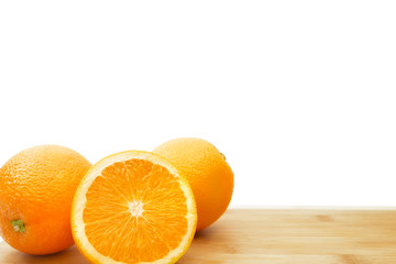 Sliced and whole oranges solated on a white background.