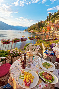Romantic dinner scene of plated Italian food on terrace overlook