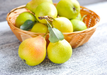 Freshly harvested pears on old wooden background