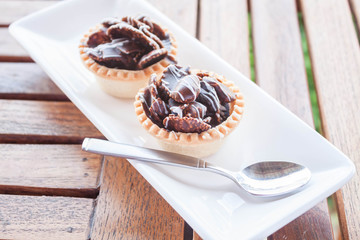 Chocolate crispy tarts on white plate