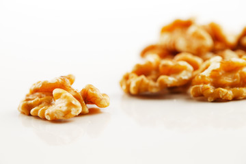 A handful of walnut seeds on white background