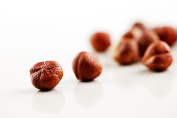 A handful of hazelnuts on a white background