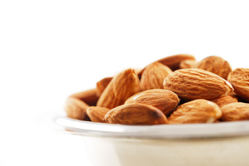 A bowl of almonds on a white background