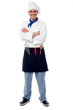 Confident young cook posing in uniform
