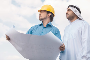 Arab businessman and builder. Low angle view of Arab businessman