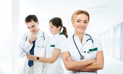 Fototapeta premium A team of young Caucasian medical workers in white clothes