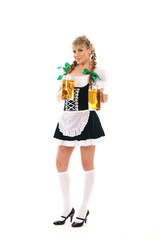 A young blond bavarian woman posing with glasses of beer