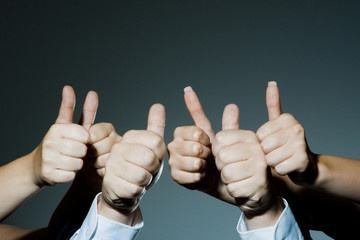 Group holding thumbs up