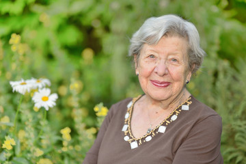 Friendly Looking Senior Woman in Her Garden 1 - obrazy, fototapety, plakaty