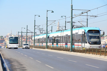 Tram, bus and car at sunny summer day on streets
