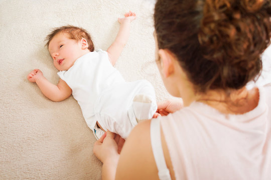 Mom Getting Her Baby Dressed