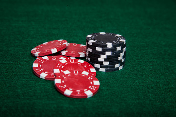 Stack of black poker chips and some red ones