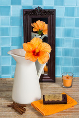 Bathroom still life with hibiscus flower in a jug