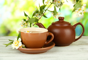 Cup of tea with jasmine, on bright background