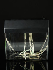 Fototapeta na wymiar Paper shredder machine with dollar banknote, isolated on black