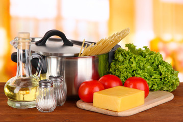 Ingredients for cooking pasta on table in kitchen