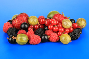 Ripe berries on blue background