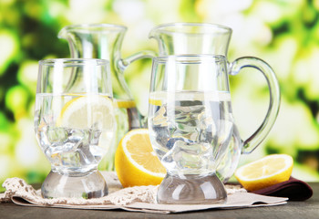 Glass pitchers of water and glasses