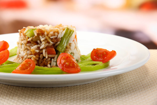 Delicious risotto with vegetables on table in cafe
