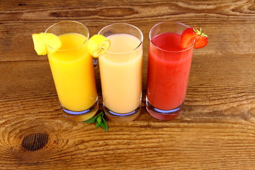 Pineapple, banana and strawberry juice in glass
