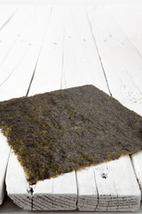 A sheet of dried seaweed on a white table