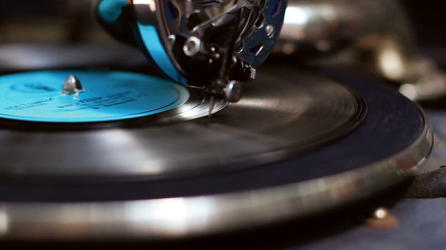 Phonograph close-up. Stylish vintage needle scratches vinyl