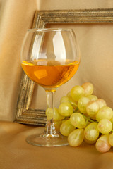 composition of frame,wine and grapes on bright background