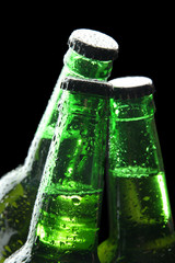 Bottles of beer on black background